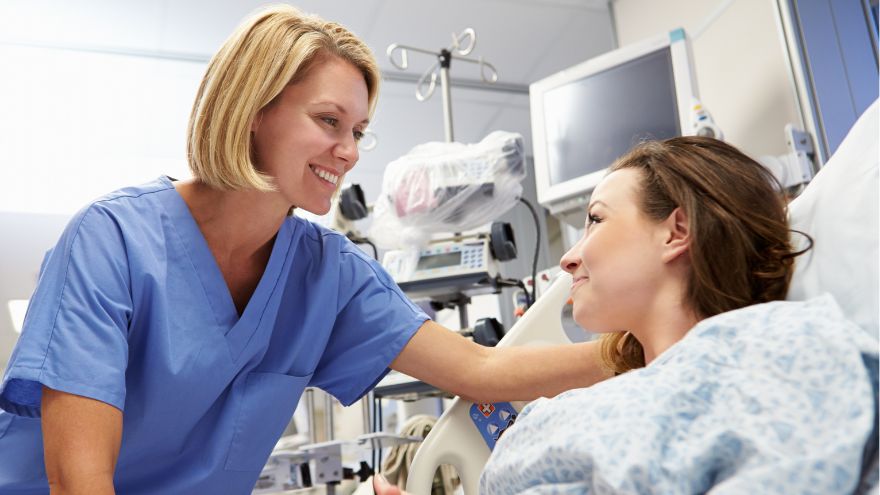 A female physician cares for a woman ER patient