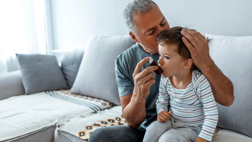 A man with a child using an inhaler