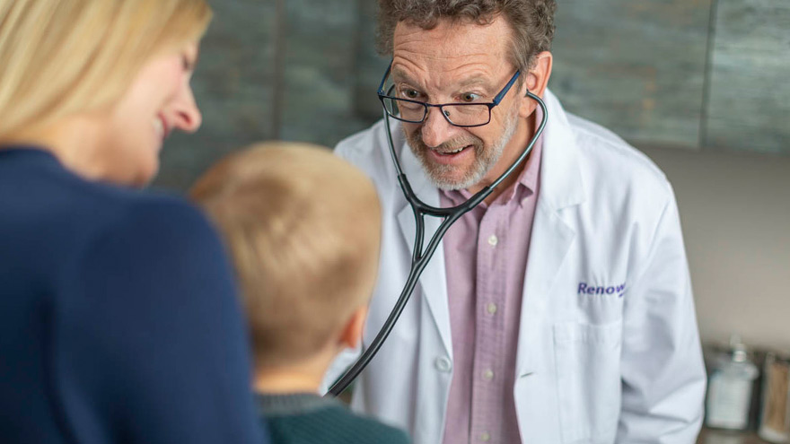 Renown Health provider examining child while mom looks on