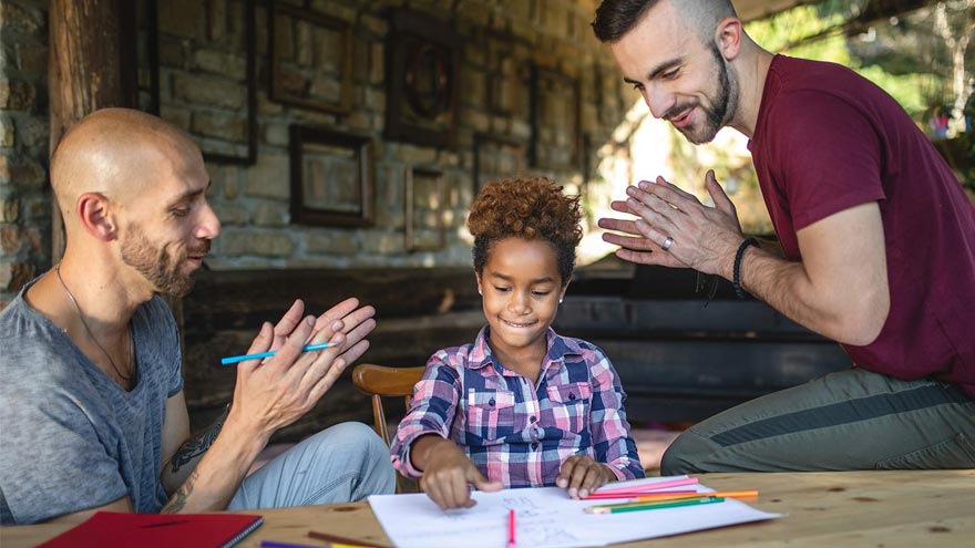 LGBTQ dads helping daughter with homework