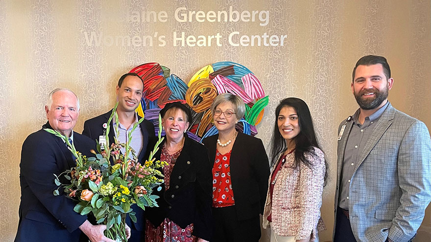 Six adults stand in front of sign that says Helaine Greenberg Women's Heart Center.
