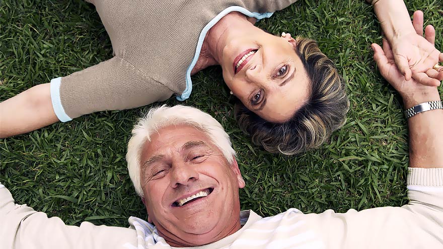 Couple laying on grass