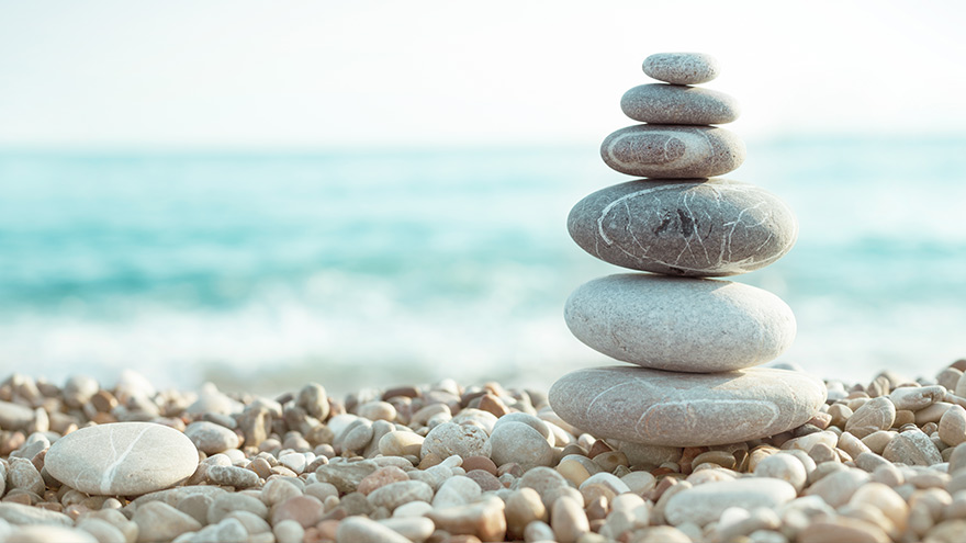 Zen rocks stacked on beach