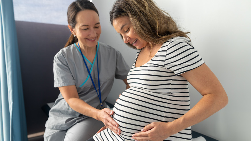 Midwife examining pregnant mom