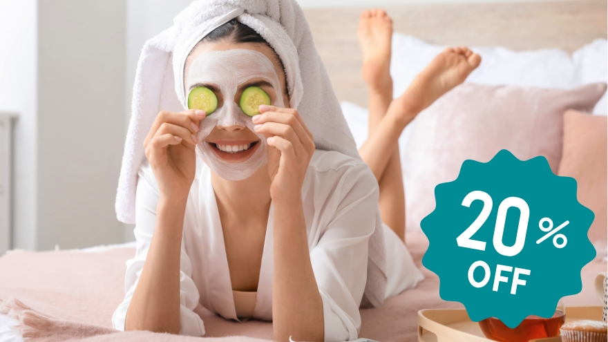 Woman holding cucumbers in front of her eyes during nightly skincare routine