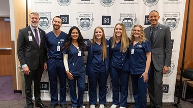 Dr. Brian Erling and Dr. Cameron Duncan stand with nursing students