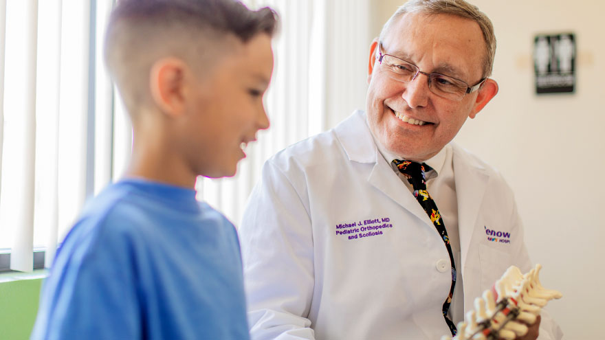 Dr. Michael Elliott talking with child patient